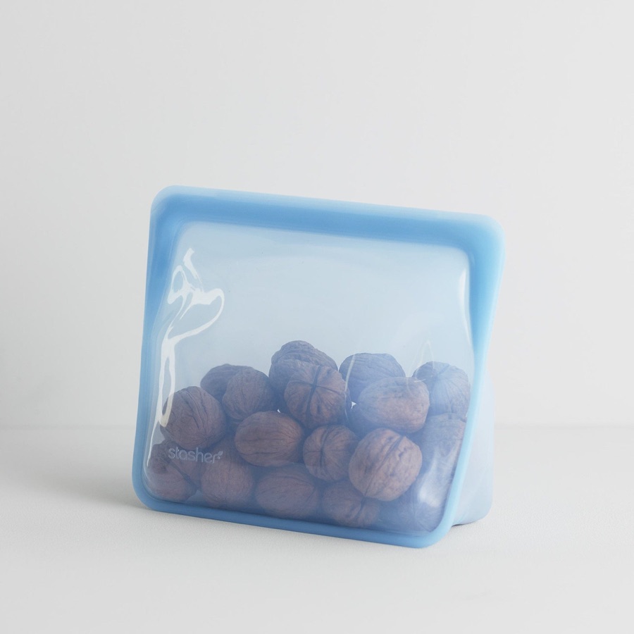 Blue Stasher Stand-Up Mid silicone bag holding food